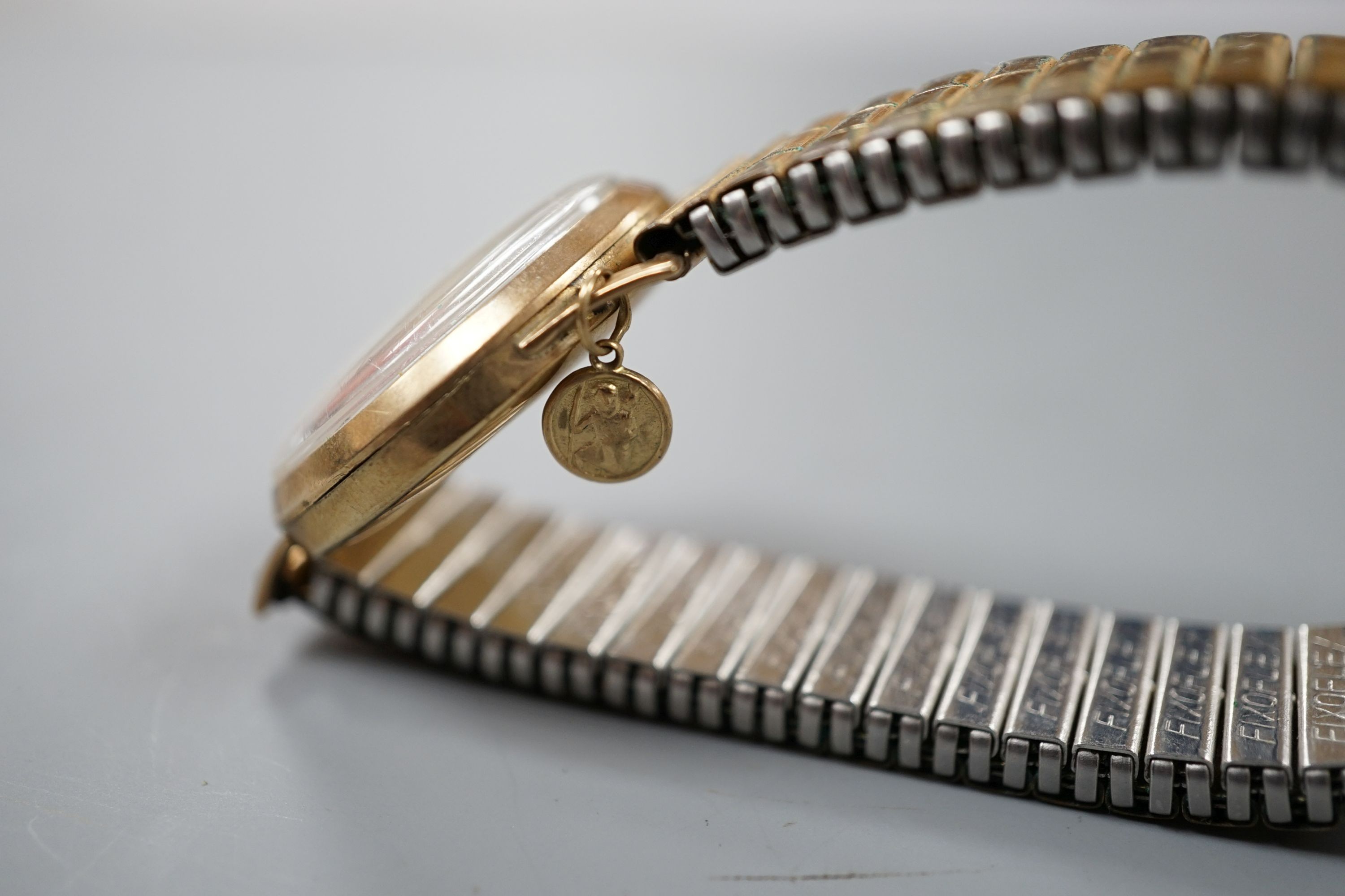 A gentleman's 9ct gold Rodania manual wind mid size wrist watch on associated gold plated expanding bracelet.